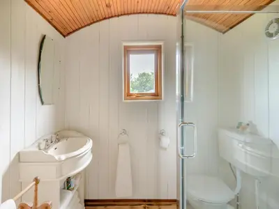 a white bathroom with a sink and a shower at Mahalia in Fordham