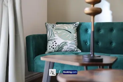 a green couch with a pillow and a table at Cozy House By AR Properties Short Lets & Serviced Accommodation Colchester in Colchester
