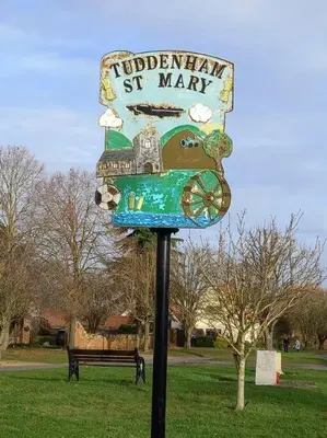 a sign in a park with a train on it at Suffolk View Apartment in Tuddenham