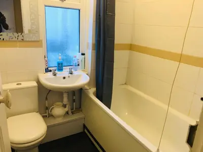 a bathroom with a toilet a sink and a bath tub at AC Lounge 119a in Rochford