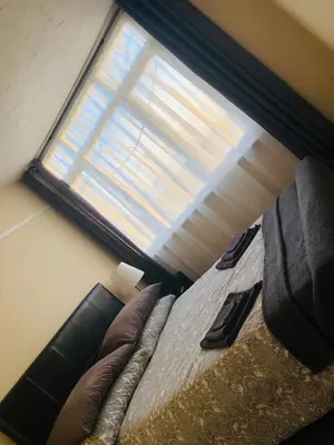 a bedroom with a bed with a large window at AC Lounge 119a in Rochford