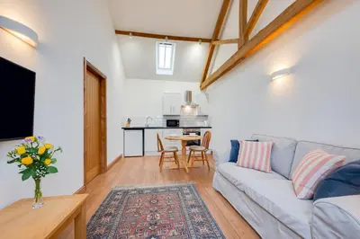 a living room with a couch and a table at 1 Bed in Quidenham oc-2233 in Quidenham