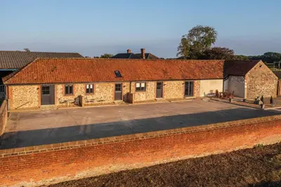 an old brick building with a large parking lot at 1 Bed in Quidenham oc-2233 in Quidenham