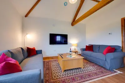 a living room with two blue couches and a coffee table at 1 Bed in Quidenham oc-2232 in Quidenham