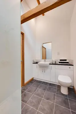 a bathroom with a white toilet and a sink at 1 Bed in Quidenham oc-2232 in Quidenham