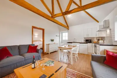 a living room with a couch and a table at 1 Bed in Quidenham oc-2232 in Quidenham