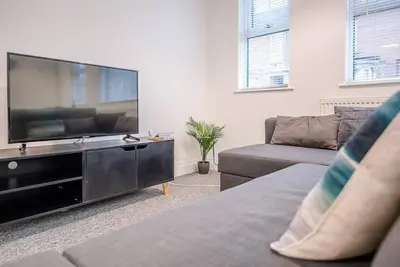 a living room with a large flat screen tv at 1 Abbey Mews, Leiston in Leiston