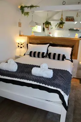 a bedroom with a large bed with two pillows at The Little Barn in Hoxne