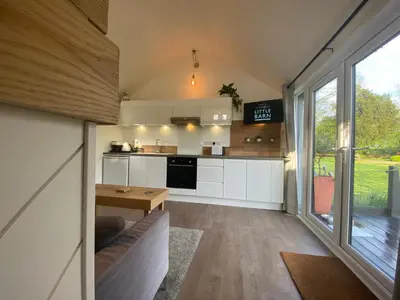 a kitchen and living room of a tiny house at The Little Barn in Hoxne
