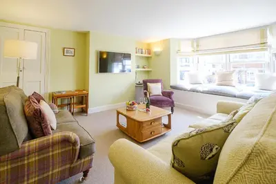 a living room with two couches and a table at Crew Quarters in Aldeburgh