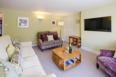 a living room with two couches and a tv at Crew Quarters in Aldeburgh
