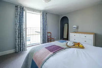 a bedroom with a bed with a tray of fruit on it at Crew Quarters in Aldeburgh