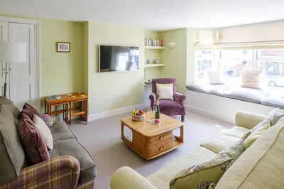 a living room with two couches and a table at Crew Quarters in Aldeburgh