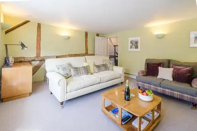 a living room with a couch and a table at Crew Quarters in Aldeburgh