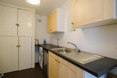 a kitchen with a sink and a counter top at Frogmore Cottage in Leiston