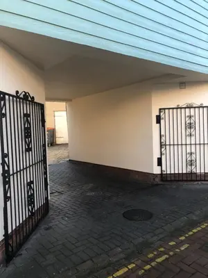 an entrance to a building with a gate at Beach Front House in Walton-on-the-Naze