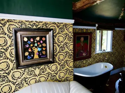 a bathroom with a tub and a painting on the wall at Huge Luxury 8 Bed Manor House Hot Tub Pool Table in Saffron Walden