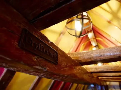 a sign on a wooden table with a light on a ceiling at Huge Luxury 8 Bed Manor House Hot Tub Pool Table in Saffron Walden