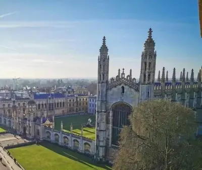 a large building with a clock tower in a city at Stylish Cambridge Home with free parking in Cambridge