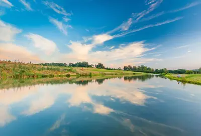 a river with a reflection of clouds in the water at Campion Lodge in Chappel