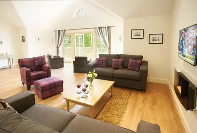 a living room with two couches and a table at Campion Lodge in Chappel
