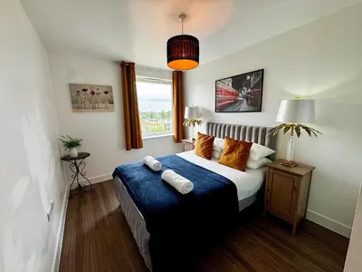 a bedroom with a bed with pillows and a window at Home2home - Mill Park in Cambridge