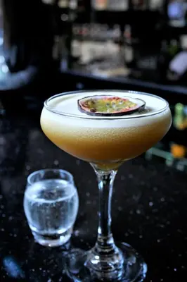 a drink in a glass on a table next to at Le Bouchon Brasserie & Hotel in Maldon