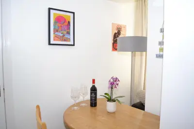 a dining room table with wine bottles and glasses at Beautiful studio in Ely in Ely
