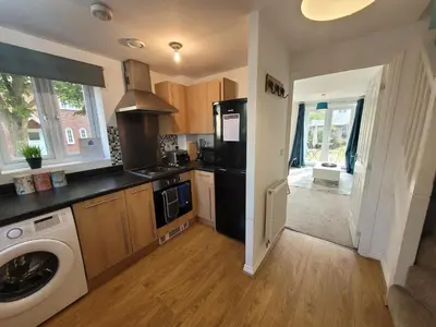 a kitchen with a black refrigerator and a dishwasher at Kensington House- The Perfect home for contractor stays in Colchester