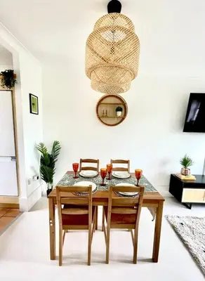 a dining room table with two chairs and a mirror at High-End 2 Bed Maisonette in Beaulieu Park in Broomfield