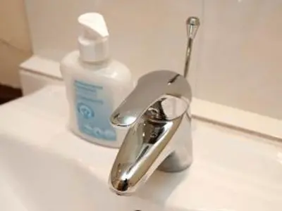 a bathroom sink with a faucet and a bottle of soap at Paddock Barn ~ Short & Long term stay, pets welcome ~ Woodbridge, Framlingham ar in Cretingham