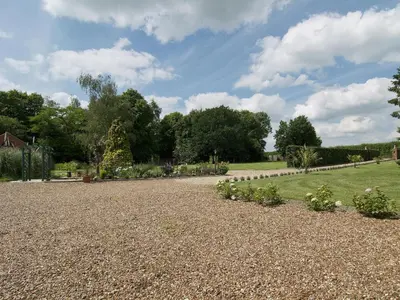 a garden with plants and a gravel driveway at St Andrews Barn in Necton