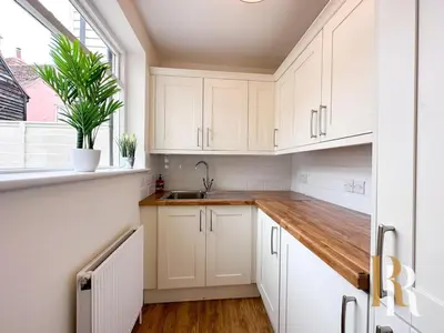 a kitchen with white cabinets and a sink and a window at Fisherman's Cottage - Harwich Breaks - BRAND NEW - long stays available great prices - get in touch for all bookings - cottage in harwich - beach stay in Harwich