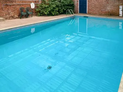 a large swimming pool with blue water at The Cottage in Fressingfield