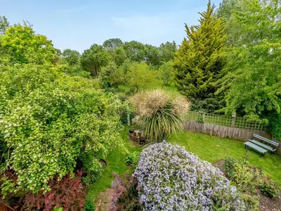 an aerial view of a garden with flowers and a bench at Bryanstown Annexe in Woodbridge