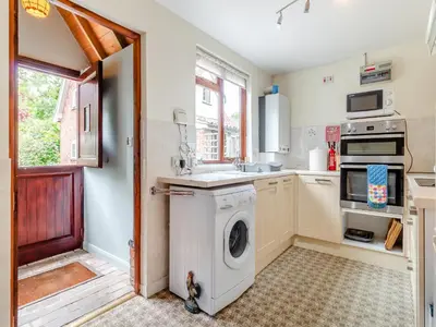 a kitchen with a washing machine and a sink at Bryanstown Annexe in Woodbridge