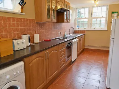a kitchen with a sink and a dishwasher at Mariners Lodge in Felixstowe