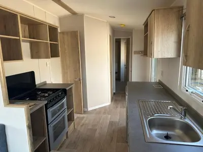 a kitchen with a sink and a stove at Mersea Retreat in West Mersea