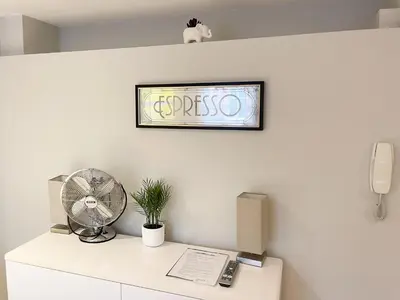 a room with a desk with a fan and a phone at Luxury Apartment with king-size Bed in Central Cambridge - easy walk to Station and City Centre in Cambridge