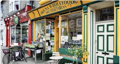 a store on a city street with a bike in front at Luxury Apartment with king-size Bed in Central Cambridge - easy walk to Station and City Centre in Cambridge