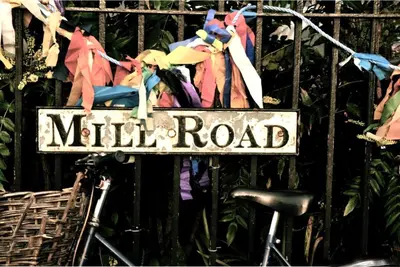 a sign that reads mill road on a fence at Luxury Apartment with king-size Bed in Central Cambridge - easy walk to Station and City Centre in Cambridge