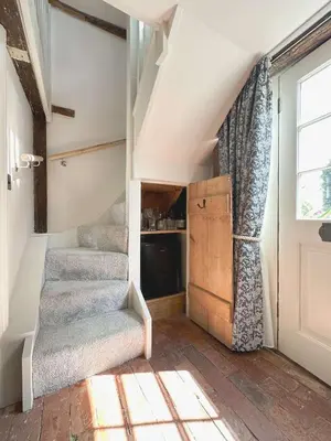 a attic room with stairs and a window at The Pear Tree Inn in Bury Saint Edmunds