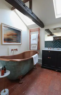 a large bathroom with a large tub and a sink at The Pear Tree Inn in Bury Saint Edmunds