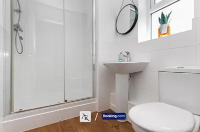 a bathroom with a shower and a toilet and a sink at Stylish House By AR Properties Short Lets & Serviced Accommodation Colchester in Colchester