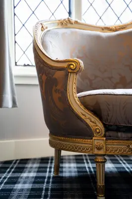 a brown chair sitting in front of a window at Kettleburgh Chequers in Kettleburgh