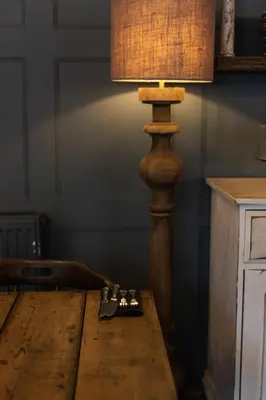 a wooden table with a lamp on top of it at Kettleburgh Chequers in Kettleburgh