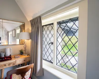 an office with a desk and a large window at Kettleburgh Chequers in Kettleburgh