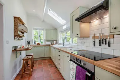 a kitchen with white cabinets and wooden counter tops at 2 Bed in Ilketshall St. Margaret oc-w27520 in Rumburgh