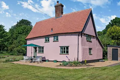 a pink house with a red roof at 2 Bed in Ilketshall St. Margaret oc-w27520 in Rumburgh