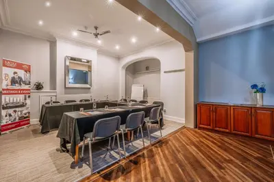 a conference room with a long table and chairs at Muthu Westcliff Hotel (Near London Southend Airport) in Southend-on-Sea